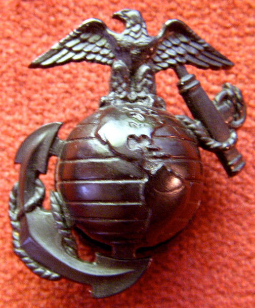 Nice Circa 1943 USMC EM Cap Badge in Plastic with Triangle 3 Marking