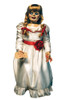 Life-size Annabelle horror prop doll in white dress with red sash, braided hair, holding a