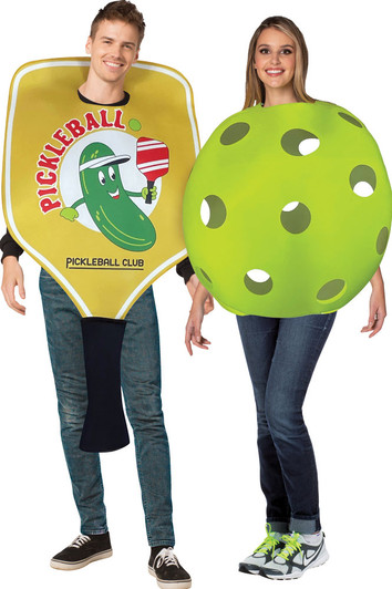 Two adults wearing pickleball couples costumes — one dressed as a yellow paddle with cartoon pickle graphic, one as a gree…