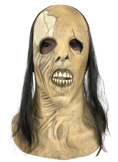 Full-head latex horror mask with wrinkled decayed skin, yellowed exposed teeth, and long straight black hair on a white ba…