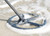 An Image showing the XP ICON Metal Detector coil in the surf on the beach.