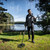Minelab X-TERRA PRO Metal Detector lifestyle photo of man holding the X-terra pro beside a body of water 