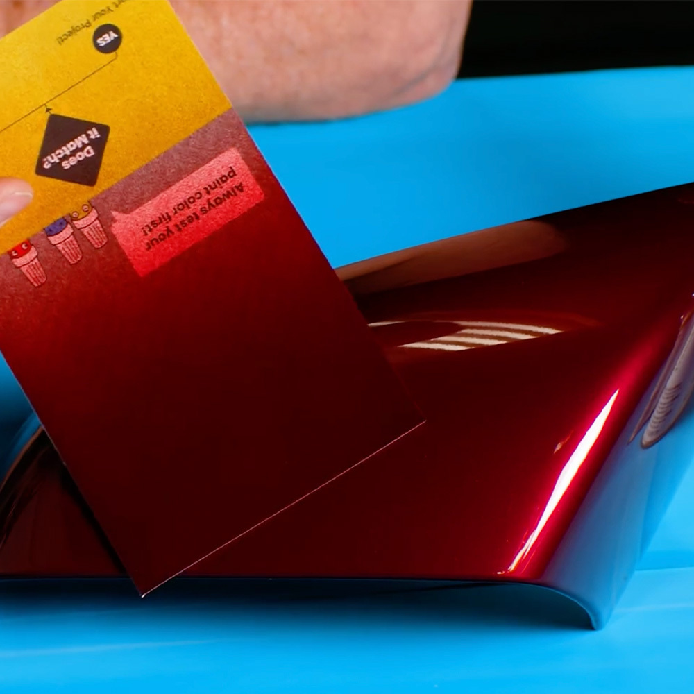 Red vehicle paint shown under different lighting conditions to demonstrate changes in color appearance.