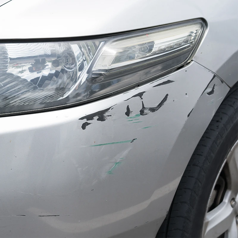 Long scratch across a silver vehicle door panel.