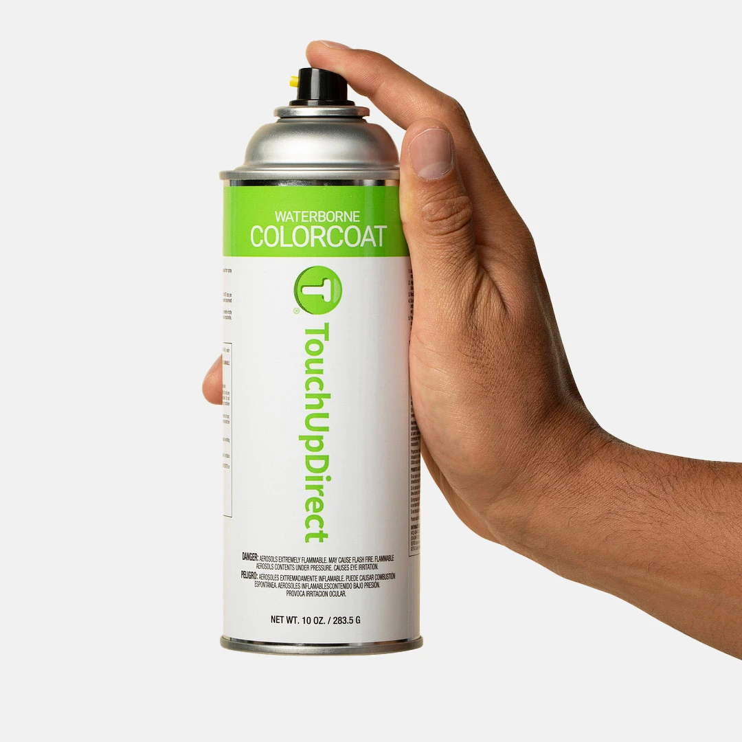 Hand holding a TouchUpDirect automotive colorcoat aerosol can