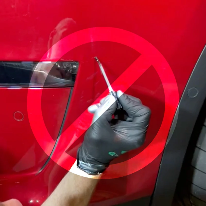 Gloved hand applying red touch up paint to a vehicle door with a warning symbol indicating clearcoat was skipped.