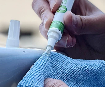 Hand priming the tip of a TouchUpDirect paint pen against a microfiber cloth