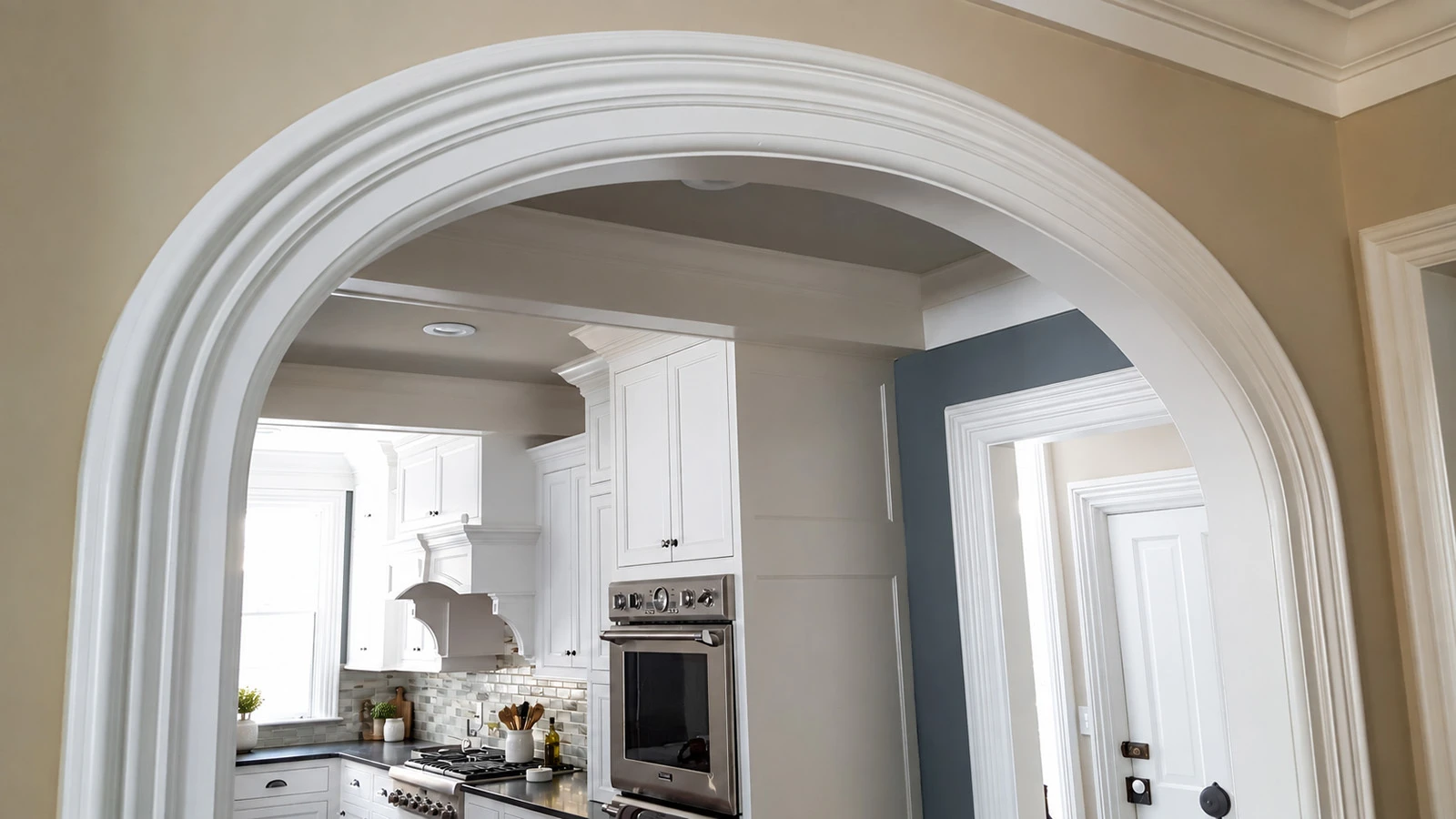 Curved white radius moulding framing an arched kitchen opening