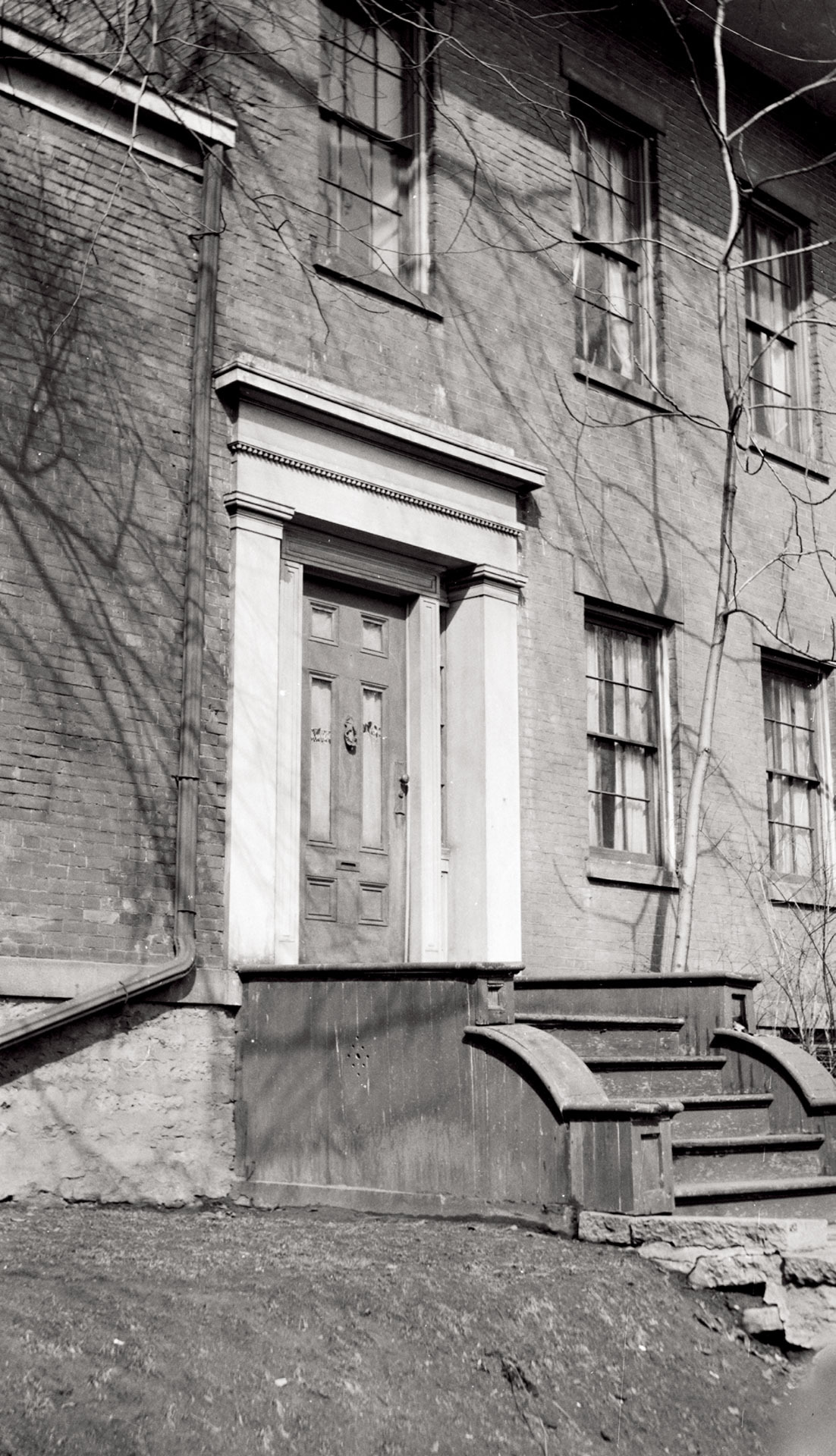 Campbell-Whittlesey house doorway with column mouldings, panel molds, casing, and steps to entrance.