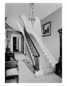 Interior of Hervey Ely house featuring door mouldings, staircase with balustrade, and interior cornice mouldings.