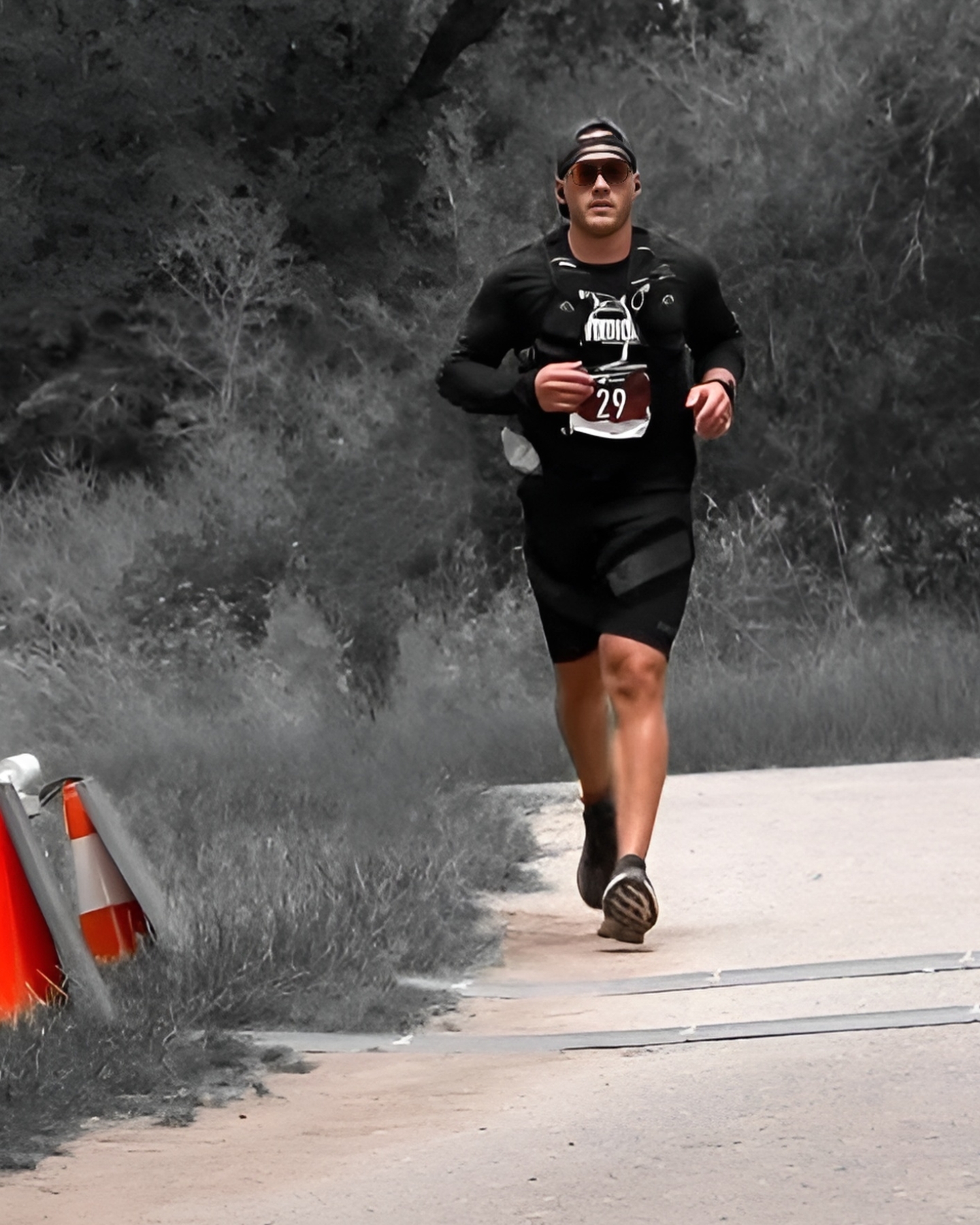 Greg Kelley wearing SAFS athletic shorts while finishing an ultra marathon. Greg is crossing the finish line in SAFS shorts.