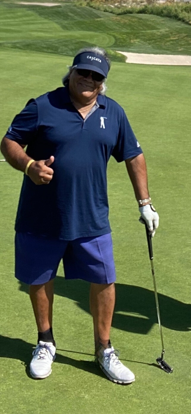 Jesse Tovar Owner of JVL Labs stands with golf club in hand while wearing SAFS shorts