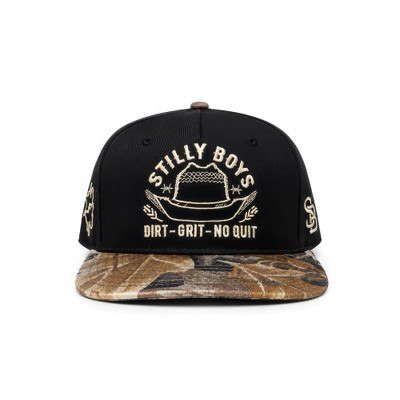 Stilly Boys Dirt Grit No Quit snapback hat in black with leaf camo flat bill and cream embroidered cowboy hat, barbed wire, and lettering — Stillwater, Oklahoma western wrestling apparel