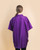 An image of a person wearing the purple Hydra Unisex Cut Smock