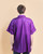 An image of a person wearing the purple Hydra Unisex Cut Smock