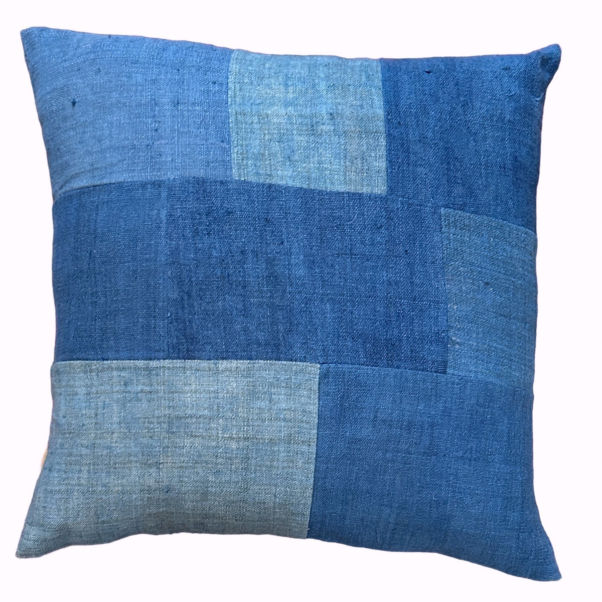 Handwoven and handspun indigo dyed hemp pillow. The pillow front is pieced with different colors of indigo dyed fabrics. The back is deep indigo blue hemp cloth.  90/10 feather down insert, zippered back. 