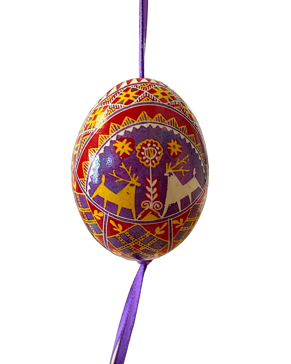 Direct from Ukrainian Folk Artist Lesia Pona- Pysanka/Ukrainian Easter Eggs. Ukrainians have been decoration eggs creating these small jewels for many generations. Archeologists have discovered ceramic Pysanky in Ukraine dating back to 1300 B.C. The symbolism comes from the ancient Trypillian culture. For Ukrainians, the Pysanka brings good fortune, wealth, health and protection to the home. We are selling these to help support Lesia during these terrible times in Ukraine. Each egg is one-of-a-kind.  Colors: lavender, red orange, white and gold.