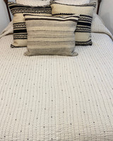 Handwoven Organic Cotton Hand Stitched Queen Quilt India. Handwoven organic kala quilt. This off-white quilt is the natural cotton color. There are rows of black hand stitching one inch apart, with small diamonds on the front side.