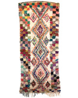 This vintage hand knotted one-of-a-kind boucherouite from outside of Marrakech. Cotton and mixd fabrics make up the pile rug. This rug would add a shot of color to your decor and would look great as a wall hanging, too. A medley of colors 