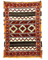 Glaoui style rug from a weaving cooperative in southern Morocco. Glaoui rugs are characterized by several weaving techniques within the body of the rug including plain weave, knotted pile, and twill pattern weaving. Long-wearing and one-of-a-kind. This small rug can work in many places in the home. Also nice on the wall. Wool with cotton warp threads. Colors:  rich red, medium indigo blue, red brown,  pumpkin, white and shades of charcoal to black.
 Details:

