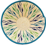 top view Handwoven medium size fiber basket made with natural sisal from sustainably harvested sources. This is from a small artisan organization that has been working in Eswatini (Swaziland) since 1985. Very sturdy. Beautiful on the table or on the wall. Colors:creamy with lime green, bright teal and deep royal blue.
