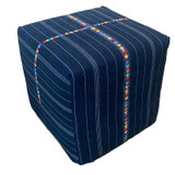 Lightweight ottoman made withhandwoven cotton traditio nal Guatemalan fabric of denim blue and white. There is a hand embroidered band with a mix of colors to brighten up the ottoman. Stuffed with dense foam, dacron batting with a plywood bottom. Use for extra seating or add a glass top to use as a side table.