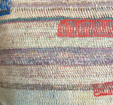 detail Hand stitched cotton pillow. We purchased this quilt from India and then took it to Guatemala where the women of UPAVIM made it into a pillow.  The front is several layers thick and worn through giving a beautiful patina. The pillow has fine rows of stitching that secures  the fabric layers and giving a nice texture. Colors: a painterly range of off- white, pale pink, pale lavender, orange red, light grey, royal blue and green. The back is a linen colored cotton suede cloth