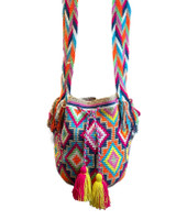 Hand crocheted using a traditional technique by the Wayuu tribe, the largest group of indigenous people from the desert region of La Guajira. Colors: fuschia, lime green, bright light blue, tan, white, orange, yellow, pink, and blue grey. Nice wide strong strap. yellow and fuchsia pompoms. Made with acrylic yarn.

