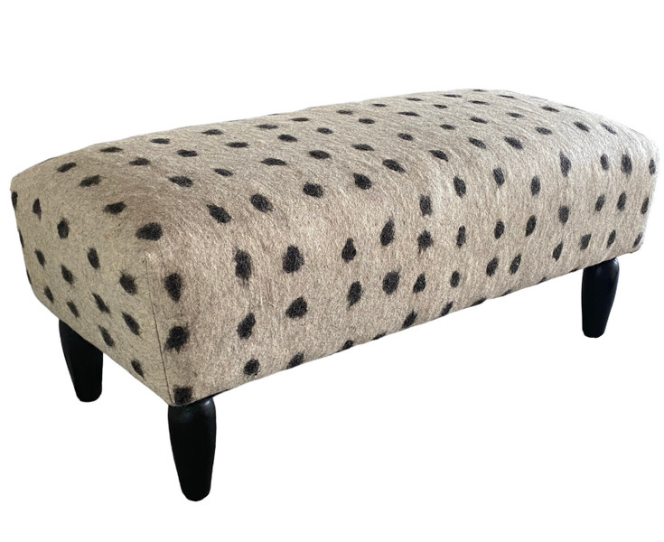  A beautiful dot bench made with dense hand felted wool. This is an unusual technique in which the natural wool fleece by Turkmen artisans in Afghanistan. The wool colors are natural- right off the sheep- black and white. Great for at the foot of the bed or in any seating area. 50" long x 24" deep X 20" tall