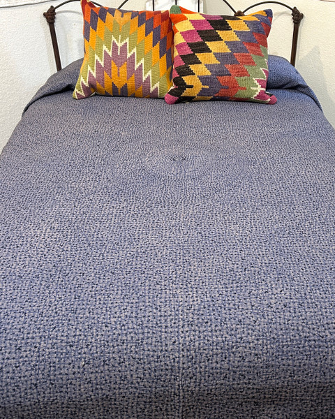 Solid colored cotton hand stitched coverlet. Chalky chalky periwinkle blue colored cotton with a fine black stitched pattern. The different stitching gives an added dimensional quality and the solid cloth takes on approx 88" x 106" On a queen size bed there is a 14" drop on the side. India