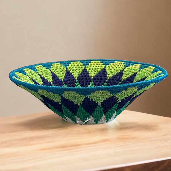 Handwoven medium size fiber basket made with natural sisal from sustainably harvested sources. This is from a small artisan organization that has been working in Eswatini (Swaziland) since 1985. Very sturdy. Beautiful on the table or on the wall. Colors: lime green, kelly green, teal, deep royal blue and cream.


