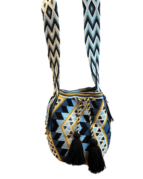 Hand crocheted using a traditional technique by the Wayuu tribe, the largest group of indigenous people from the desert region of La Guajira. Colors: bright light blue, dark Prussian blue, ochre, cream and black.. Nice wide strong strap. Made with acrylic yarn.
