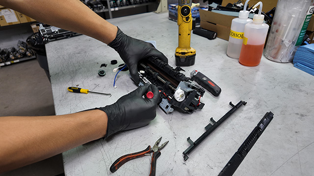 technician working on a refurbished fuser unit