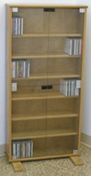 DVD bookcase with glass doors in oak or maple by Decibel Designs