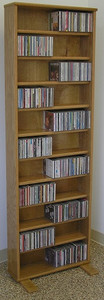 DVD rack 72 inches high shown in light brown oak finish. Comes with 10 adjustable shelves. All cabinet grade plywood construction. Beautiful satin finish.tel 888.850.5589 decibeldesigns.com