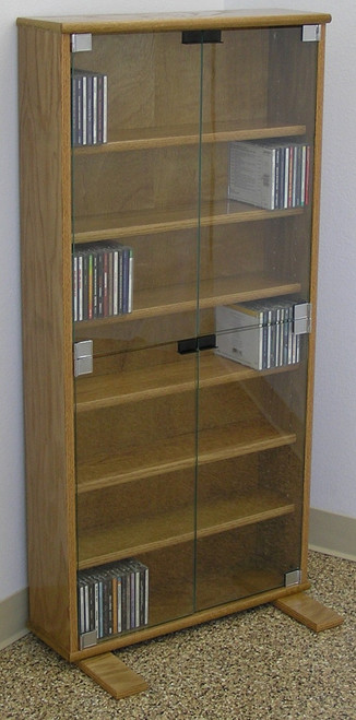 DVD storage cabinet 48"H shown in Light Brown Oak with clear glass doors. decibeldesigns.com 888.850.5589