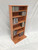 Oblique view of DVD storage cabinet 48"H shown in Minwax Colonial Maple on maple wood. decibeldesigns.com 888.850.5589