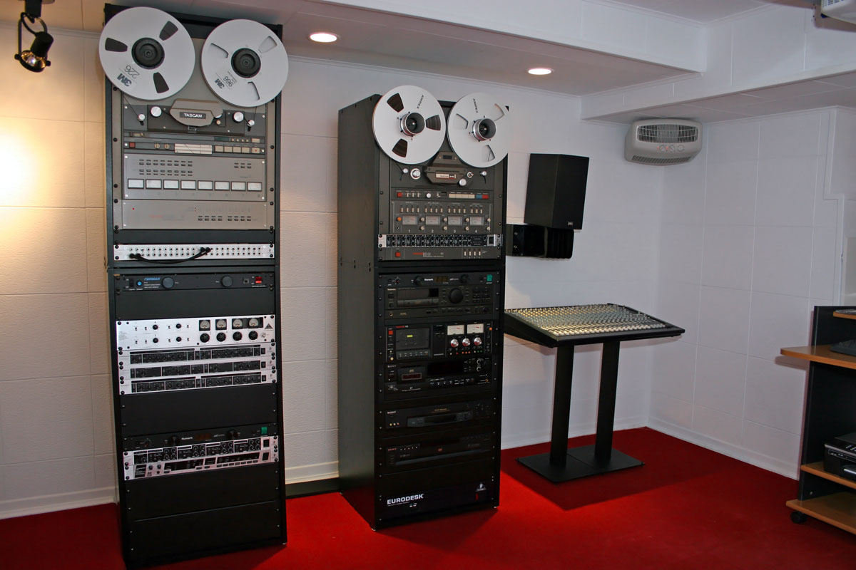 Simple black reel to reel cabinets about 6 feet tall.