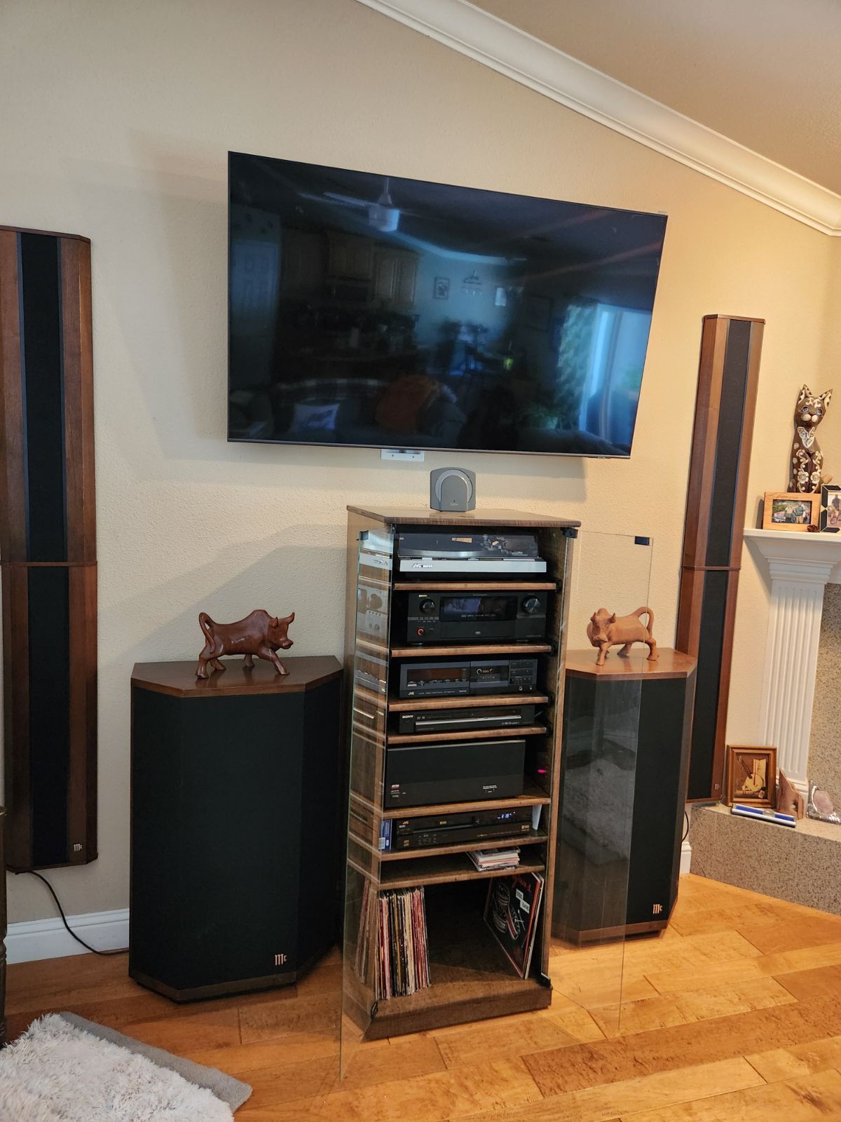 Audio rack with glass doors 61" high. Shown in Special Walnut finish on oak with full length clear tempered glass doors. Also has several adjustable slide out shelves in the top section. https:// decibeldesigns.com  805.331.8506