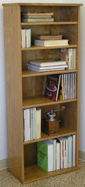 Bookcase shelving 60"H with five adjustable shelves.  Shown in light brown oak finish. Glass doors available. Stores hardbound books, LP's, and lazer discs. 23" wide all formaldehyde free plywood construction. Available in Oak or Maple unfinished or with standard or custom finishes.Simple assembly. Matching CD DVD cabinets and stereo cabinets. We're here to create quality for you! decibeldesigns.com 805.331.8506