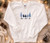 PEACE LOVE JOY EMBROIDERED DESIGN

GILDAN HEAVY BLEND 50/50 WHITE CREWNECK SWEATSHIRT