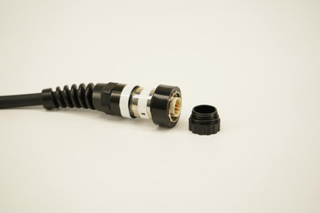 Dive And See DNC-4011 metal protective cap removed from waterproof connector, showing internal gold-plated pins for underwater cable protection