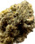 This image captures a slightly broader view of the "Ripkitty Black Truffle THCA Flower," showcasing the dark green and purplish hues that give this strain its unique visual appeal. The tight, compact structure of the bud is evident, and the heavy layer of trichomes provides a glistening effect, indicating its high THCA content. The subtle hints of orange pistils add a contrast to the overall color palette.