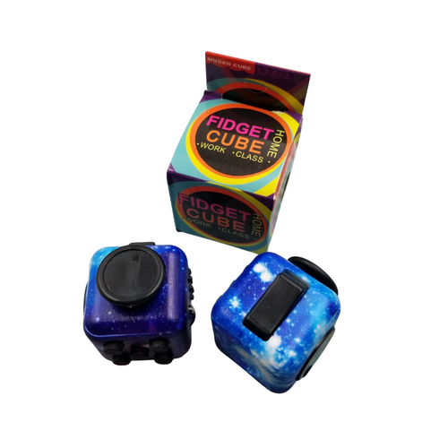 Two fidget cubes resting on a table, with the product box behind.