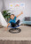 Girl sitting and spinning on the Bintiva Sit and Spin Seat in a playroom, arms raised and smiling
