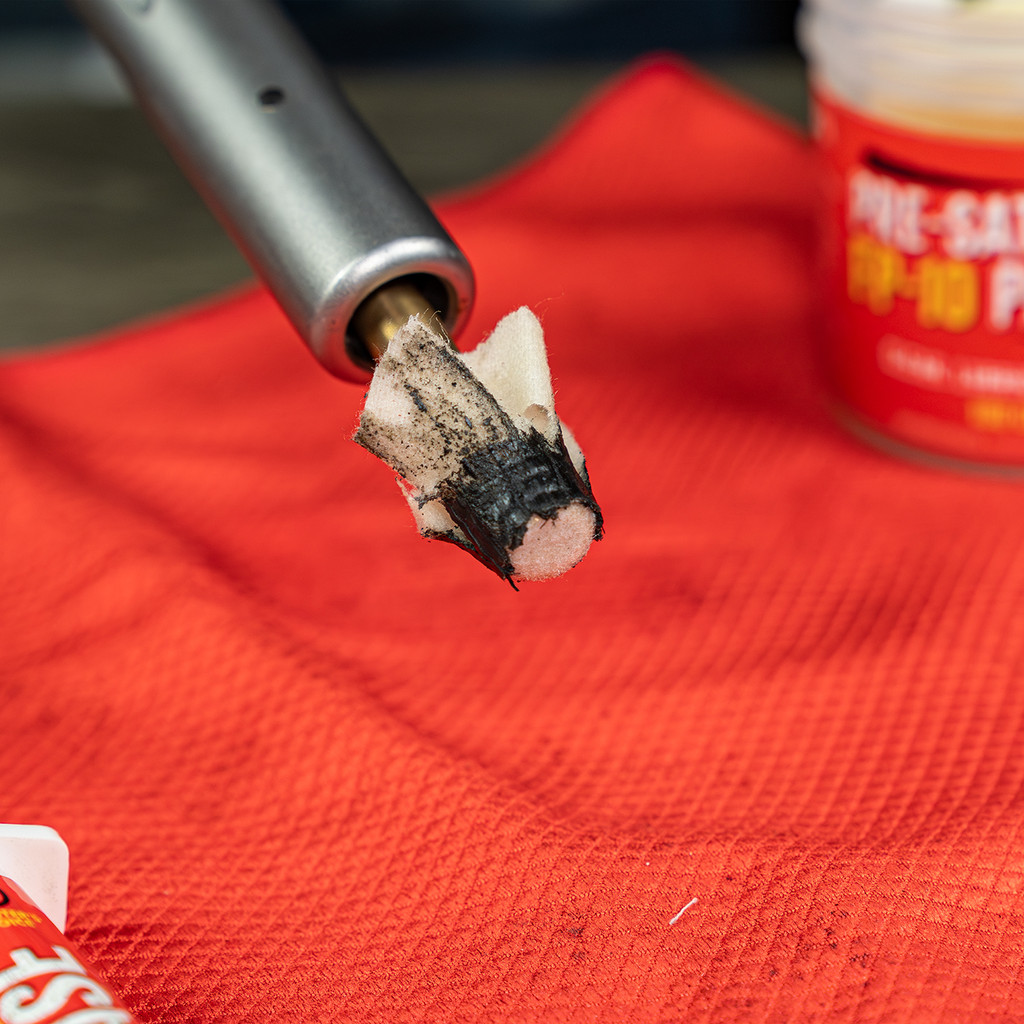  Lifestyle Image of Shooter's Choice Muzzleloader Cleaning Accessory Pack presaturated patches in use on a muzzleloader