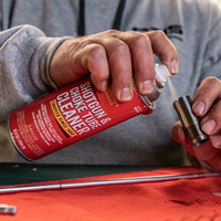 Product image of Shooter's Choice Shotgun and Choke Tube Cleaner  in use cleaning a shotgun choke tube