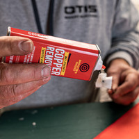 product image Shooter's Choice Maximum Strength Copper Remover in use being applied to a gun cleaning patch