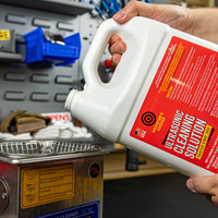 Lifestyle image of pouring Shooter's Choice ultrasonic cleaning solution into ultrasonic cleaning device