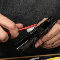 Lifestyle image of image of Shooter's Choice .40 caliber Pistol Cleaning Kit AP brush shown in use